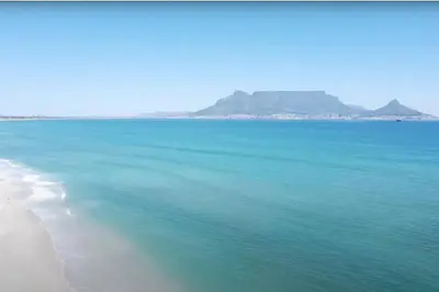 a view of a beach with blue water at Dolphin Beach Estate 131sm in Cape Town