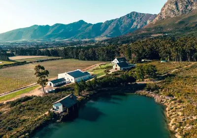 an aerial view of a house and a lake at Wildeberg Dam House Cottage in Franschhoek