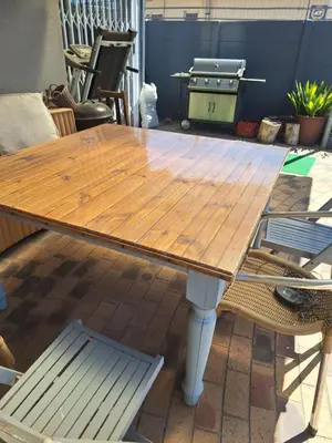 a wooden table sitting on top of a patio at Kraaifontein Family Home in Cape Town