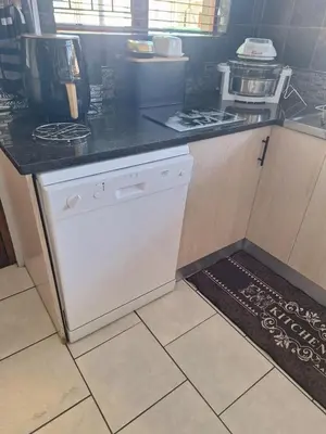 a kitchen with a dishwasher and a counter top at Kraaifontein Family Home in Cape Town