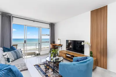 a living room with a view of the ocean at The Bay A602 in Cape Town