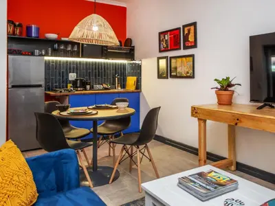 a living room with a table and a kitchen at Haus Michau in Strand
