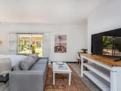 a living room with a couch and a flat screen tv at Haus Michau in Strand