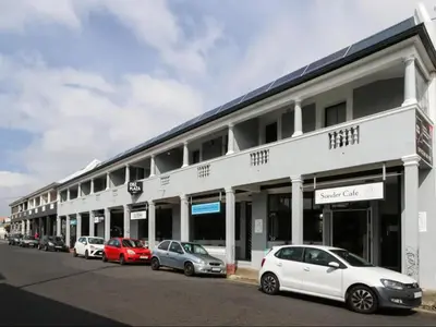 a row of cars parked in front of a building at Obs Centre Twin Peaks in Cape Town