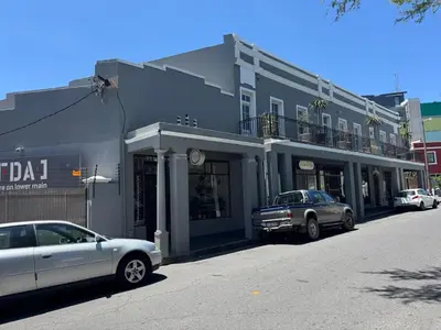 a gray building with cars parked in front of it at Obs Centre Luxe Loft in Cape Town