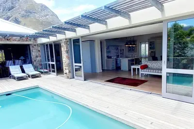 a house with a swimming pool and a patio at Knight's House 6 sleeper in Hermanus
