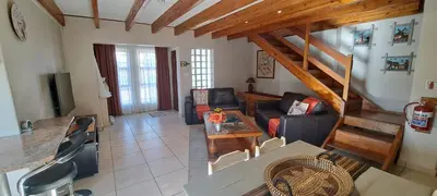 a living room with a couch and a table at 8 on Lily Self catering in Cape Town