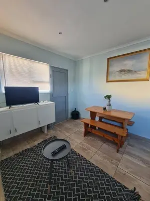 a living room with a table and a table sidx sidx sidx sidx at H & E Sunset Paradise in Fisherhaven