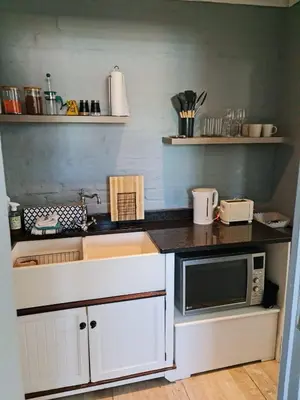 a kitchen with a sink and a microwave at H & E Sunset Paradise in Fisherhaven