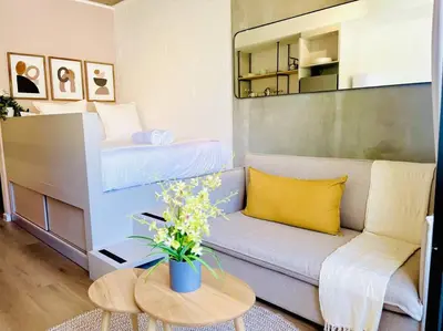 a small living room with a couch and a bed at Seapoint Solace in Cape Town