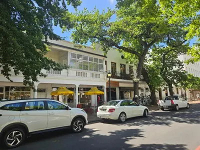 two white cars parked in front of a building at PinotageLuxuryCollection 16 Ryneveld Plaza in Stellenbosch