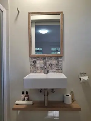 a bathroom with a white sink and a mirror at Paradysrus in Stellenbosch