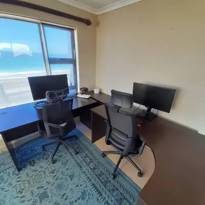 an office with two desks with two monitors and two chairs at Jacuzzi with 270 views right on beach in Cape Town