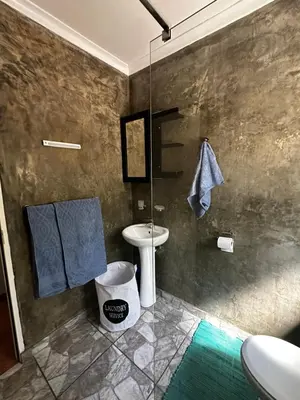 a bathroom with a sink and a glass shower at Jacob's Rest in Cape Town