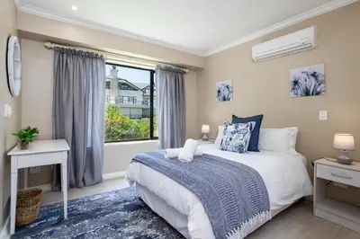a bedroom with a bed and a window at Luxury Lodge 4F Pearl Valley Golf Estate in Simondium