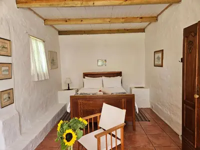 a bedroom with a bed and a table and chairs at Whipstock Guest Farm in McGregor