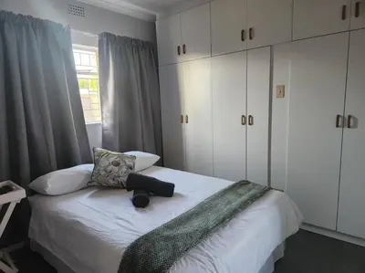 a bedroom with a bed with a suitcase on it at HartebeesDen in Worcester