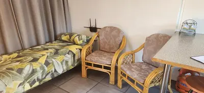 a couple of chairs and a couch in a room at HartebeesDen in Worcester