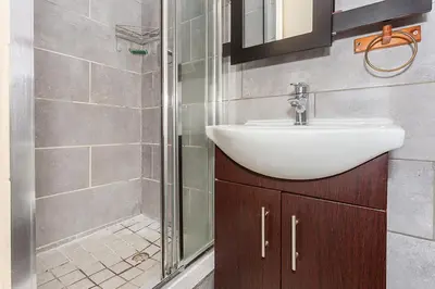 a bathroom with a sink and a shower at Secured 3-Bedroom Townhouse in Cape Town