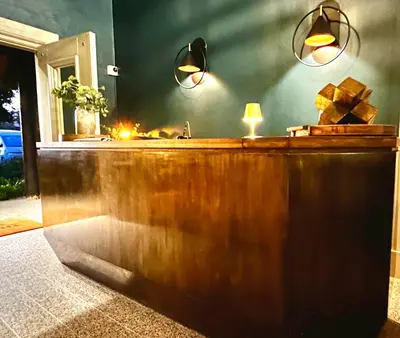 a bar with two lights on top of it at The Thatch House Boutique Hotel, Hermanus in Hermanus
