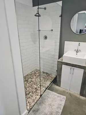 a bathroom with a shower and a sink at Blouberg Rise Cottage in Cape Town