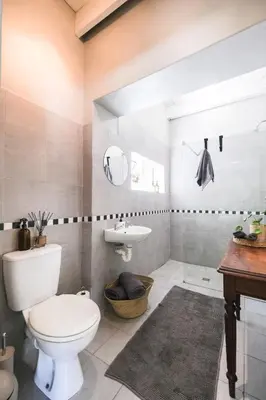a bathroom with a toilet and a sink at 1-Bed Cottage ,Sleeps 3, Walk to Boys High and Bossa in Paarl
