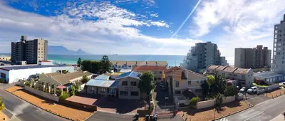 an aerial view of a city with buildings and the ocean at Beachside Escape in Cape Town