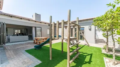 a playground in the backyard of a house at Paraiso - A cozy retreat , your home away from home in Cape Town