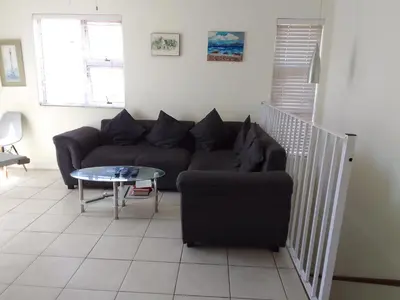 a living room with a couch and a table at Nortey is palace in Cape Town
