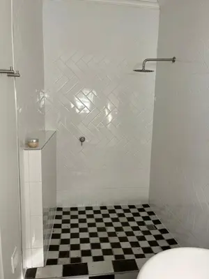 a bathroom with a black and white checkered floor at On Musson in Hermanus