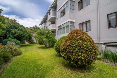 a large bush in front of a building at Oak Terrace 28 in Hermanus