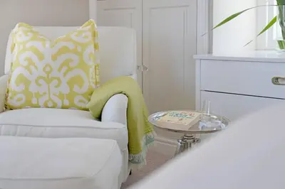 a living room with a white chair and a table at Farm Lorraine The Loft Cottage in Franschhoek
