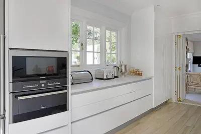 a kitchen with a counter with a microwave and a tv at Farm Lorraine The Loft Cottage in Franschhoek
