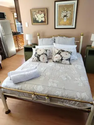 a bed with pillows on it in a bedroom at Rustig by die See in Bettyʼs Bay