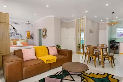 a living room with a couch and a table at 323 Leisure Bay in Cape Town