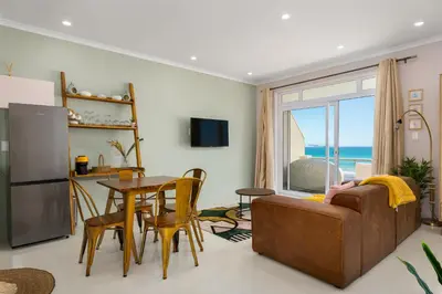 a living room with a couch and a table at 323 Leisure Bay in Cape Town