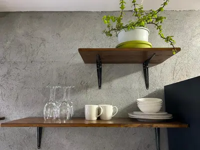 a wooden shelf with glasses and a potted plant on it at La Casetta, Garden Retreat in Cape Town
