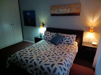 a bedroom with a bed with two pillows on it at LAAT Slaap Self-Catering Accommodation in Kleinmond