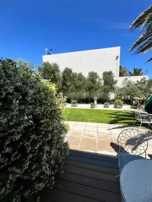 a view of a building from the garden at Charming Flatlet Near the Amazing Sunset Beach in Cape Town