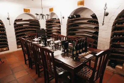 a dining room with a table with wine bottles at Mitre's Edge Simonsberg Studio in Klapmuts