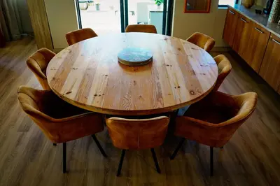 a wooden table with chairs and a bowl on top at Knightsbridge Luxury Escape in Cape Town