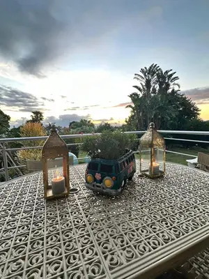 a table with a planter and lights on it at Bonita Vista Plattekloof in Cape Town