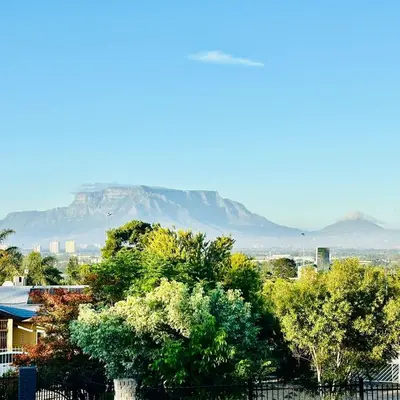 a view of a mountain in the distance with trees at Bonita Vista Plattekloof in Cape Town