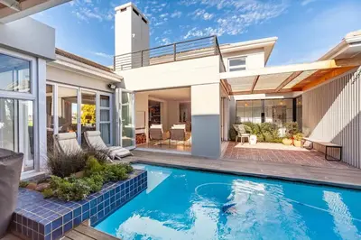 a swimming pool in the backyard of a house at Sunsets Jasmine Villa in Cape Town