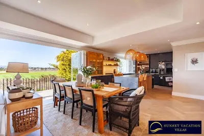 a kitchen and dining room with a table and chairs at Sunsets Jasmine Villa in Cape Town