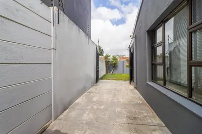 an empty alleyway between two buildings next to a building at En-suite Room, Walking distance to Kite Beach in Cape Town