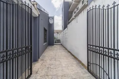 an alley with a gate in a building at En-suite Room, Walking distance to Kite Beach in Cape Town
