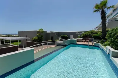a swimming pool on the roof of a building at Dolphin Hill Apartment, Cape Town, Dolphin Beach in Cape Town