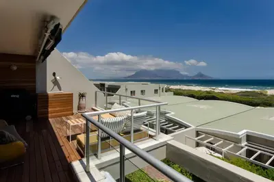 a balcony of a house with a view of the ocean at Dolphin Hill Apartment, Cape Town, Dolphin Beach in Cape Town