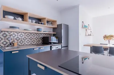 a kitchen with blue cabinets and a counter top at 2stay Apartment Calla - Cape Town Bloubergstrand in Cape Town